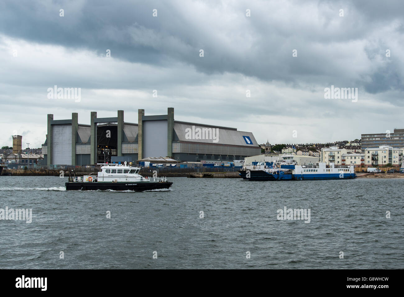 The Frigate Refit Complex at HMNB Devonport, Plymouth, Devon. With pilot boat SD Tamar Spirit and the Torpoint Ferry, Plym II. Stock Photo