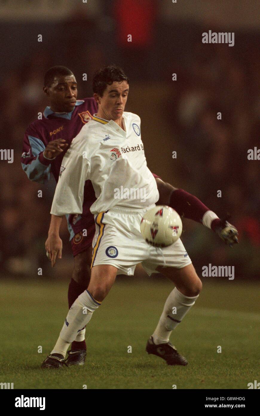 Soccer - FA Carling Premiership - Leeds United v West Ham United. Leeds United's Gary Kelly (right) shields the ball from West Ham United's Andy Impey (left) Stock Photo