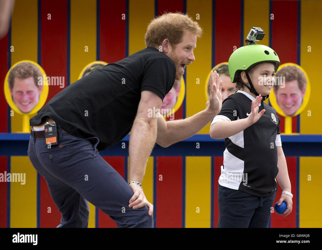 Prince Harry takes part in filming a segment where a photo of him is