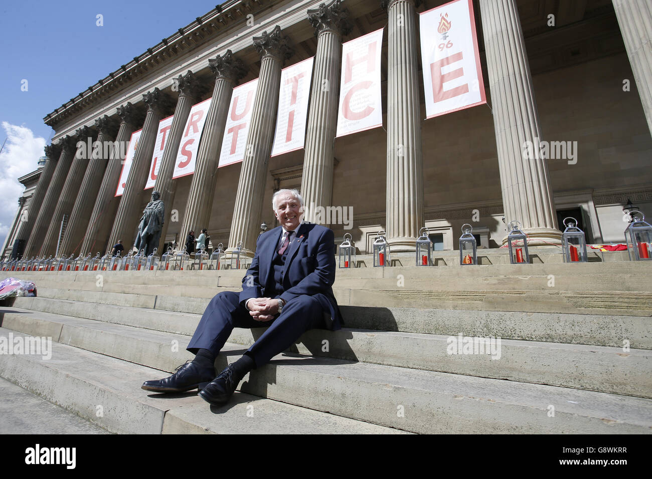 Trevor Hicks, whose daughters Sarah and Vicki died in the Hillsborough disaster, sits on the steps of St George's Hall in Liverpool, where there is a giant banner and candle lit for each of the 96 Liverpool fans who died as a result of the Hillsborough disaster, as they will be commemorated later after an inquest jury ruled they were unlawfully killed, triggering calls for further action. Stock Photo