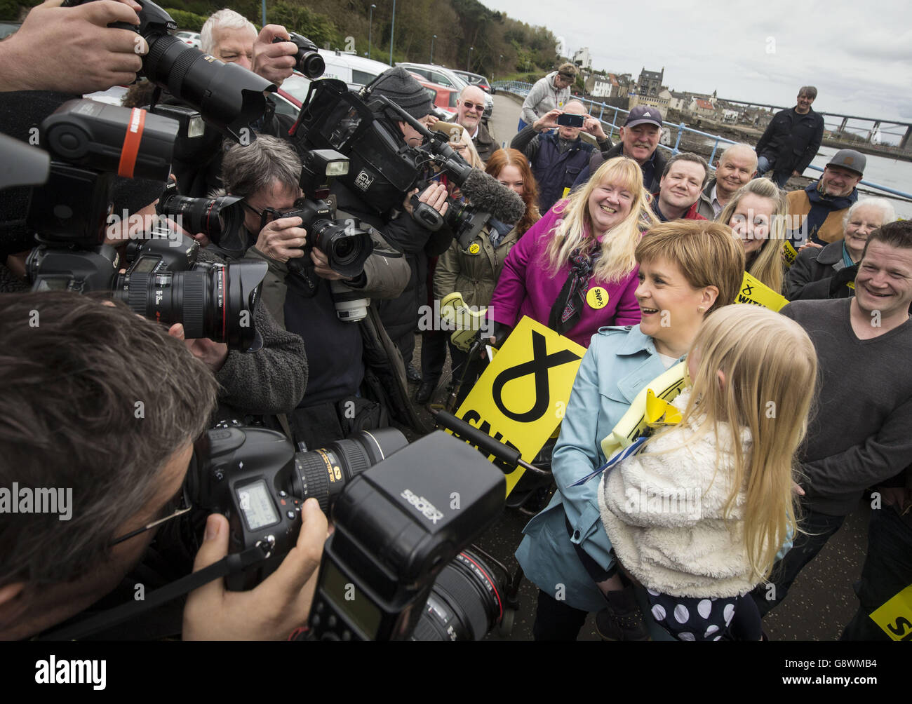 First Minister Nicola Sturgeon holds five-year-old Holly Baird on the campaign trail in South Queensferry, Scotland. Stock Photo