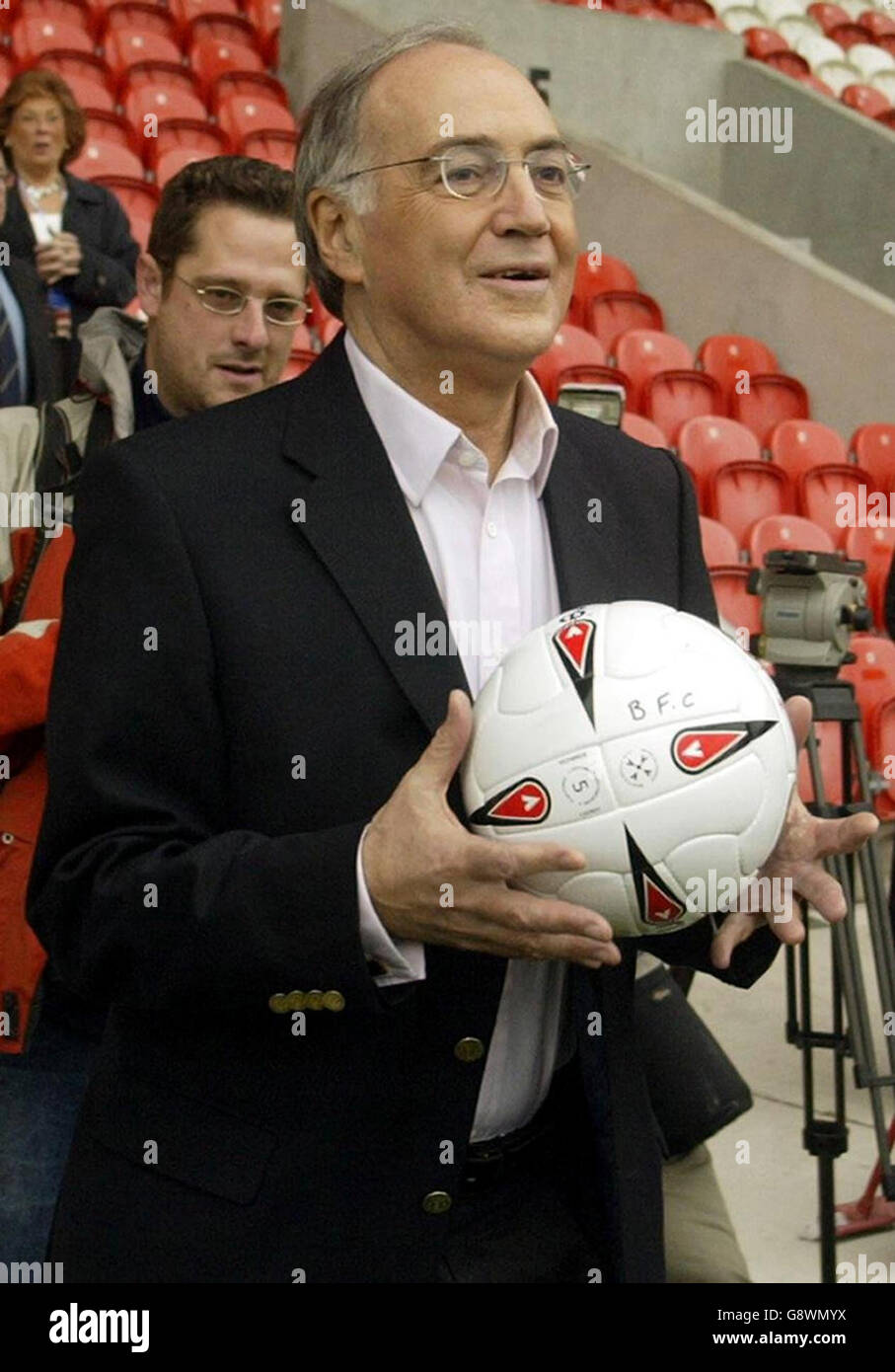 Conservative leader Michael Howard holds a football as he watches members of his party's football team play a pre-conference match against a team of Journalists at Blackpool FC,. Stock Photo