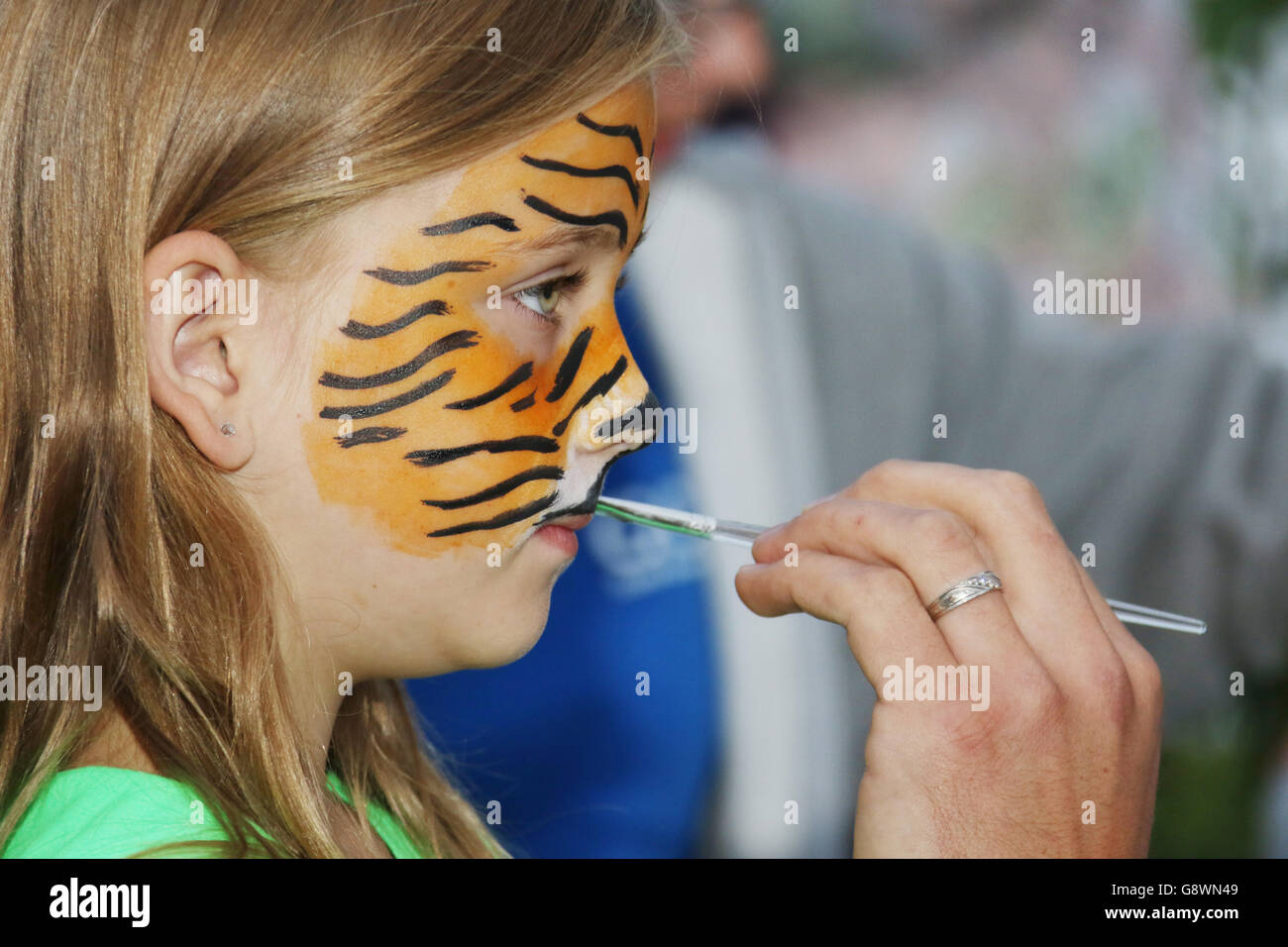 Young Girl getting face painting as a tiger. Beavercreek Popcorn