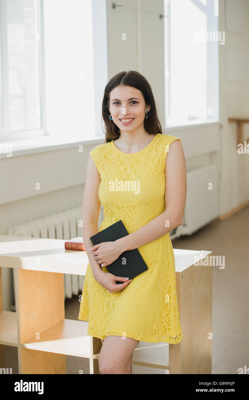 Happy young smiling student girl with book Stock Photo - Alamy