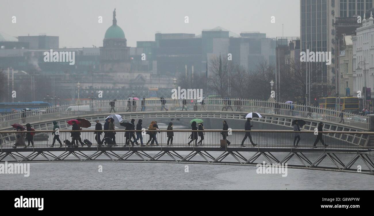 Pedestrians walk in an April shower in Dublin city centre Stock Photo