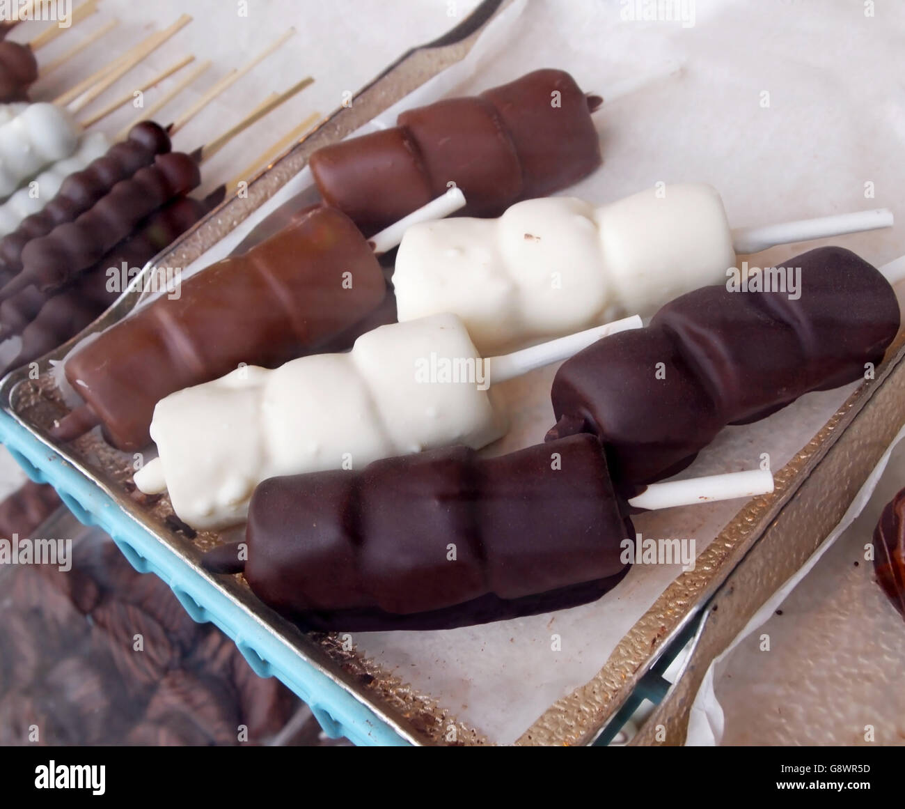 Marshmallow candy enrobed in dark chocolate, white chocolate, and milk