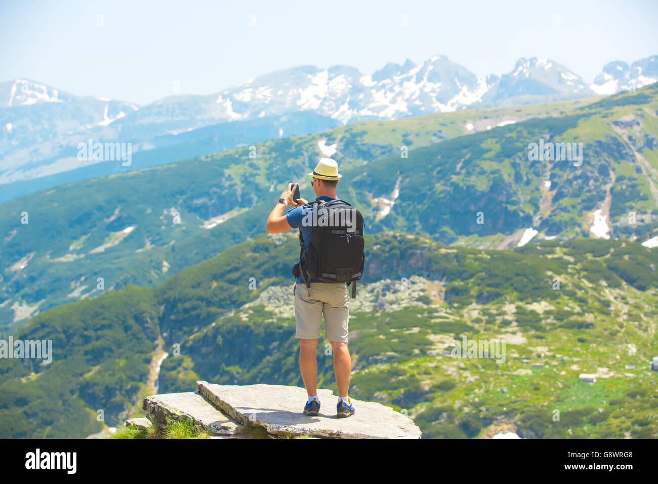 Hiker taking photo of beautiful mountain landscape Stock Photo