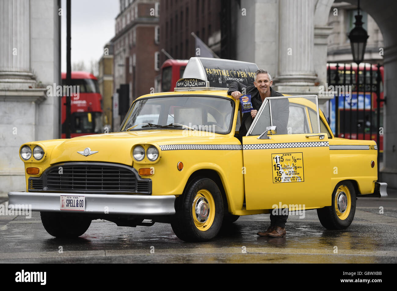 Gary Lineker by a yellow New York taxi as he brings Thailand, Morocco, India and New York to Marble Arch, London, for the launch of Walkers Spell & Go campaign, where people collect letters in packs of crisps to be in with a chance of winning one of 20,000 holidays up for grabs. Stock Photo