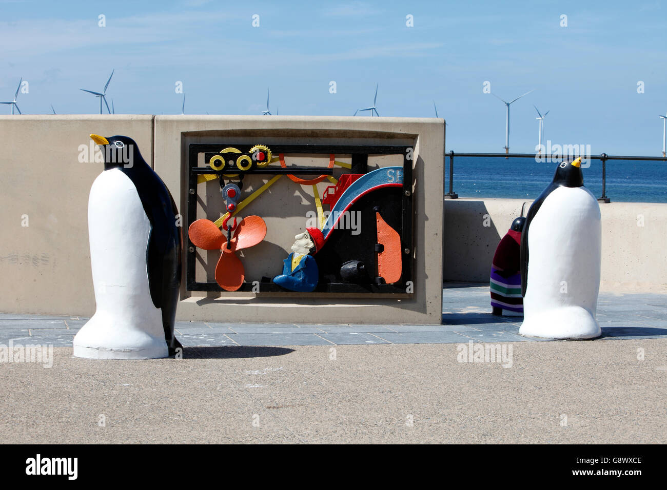 Penguin bollards in front of an industrial plaque on Redcar seafront. UK Stock Photo