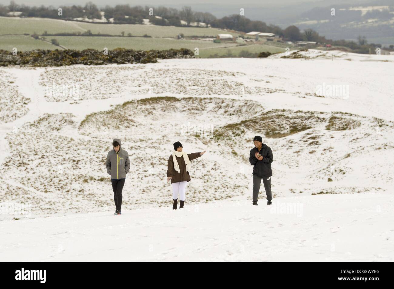People walking in snow on Cleeve Hill, Cheltenham, as a cold snap ...