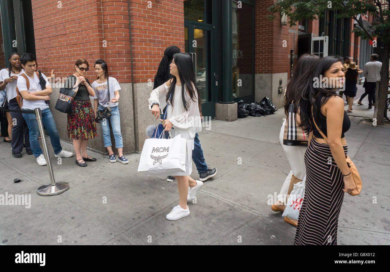 Fashion and budget conscious shoppers flock to the MCM sample sale in Soho in New York on Thursday, June 23, 2016. The German company, founded in 1976 sells luxury priced leather goods and was acquired by the Korea-based Sungjoo Group in 2005 which revitalized the brand. (© Richard B. Levine) Stock Photo