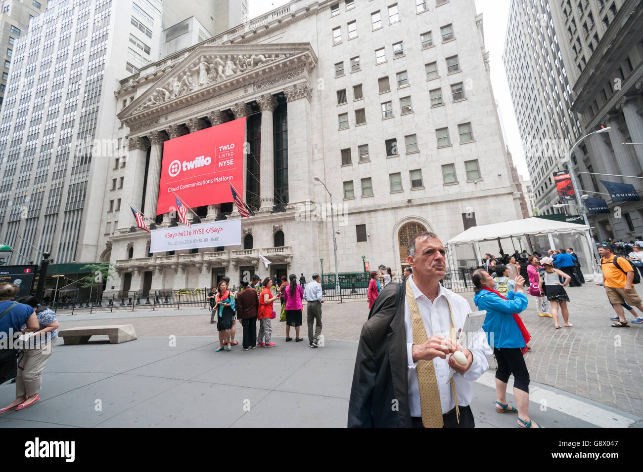 The New York Stock Exchange is decorated for the technology company Twilio's initial public offering on Thursday, June 23, 2016. Twilio, a technology company that sells a messaging service that enables developers to construct apps that interact with consumers has Uber, WhatsApp, Nordstrom and others as its clients.  (© Richard B. Levine) Stock Photo