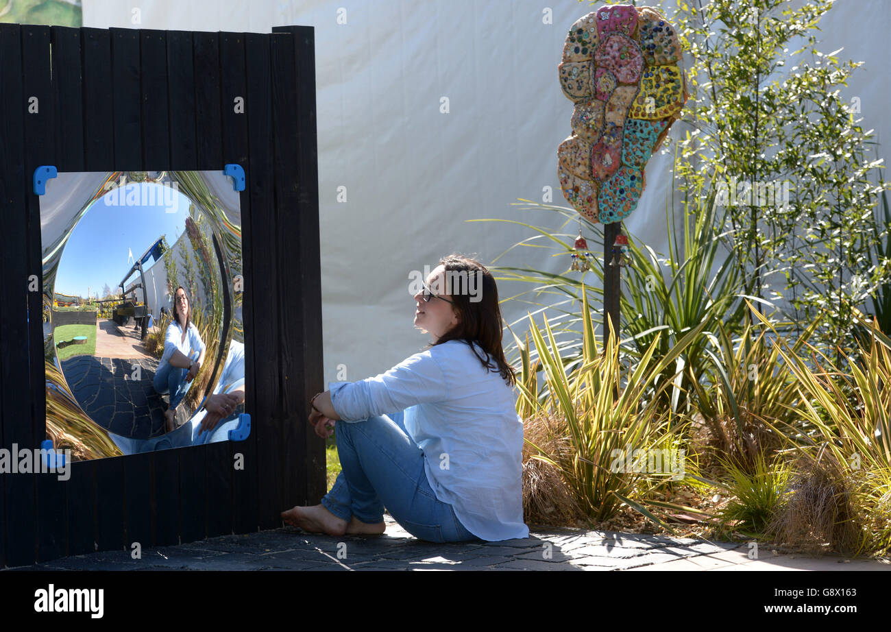 Lorna Batchelor sits inside George's Garden a sensory garden designed for children with special needs during staging day at the Harrogate Spring Flower Show, North Yorkshire. Stock Photo