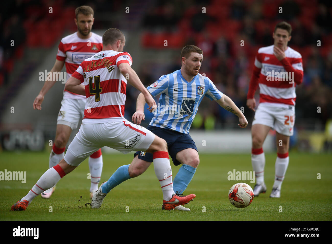 Doncaster Rovers' Luke McCullough challenges Coventry City's John Fleck (centre) Stock Photo