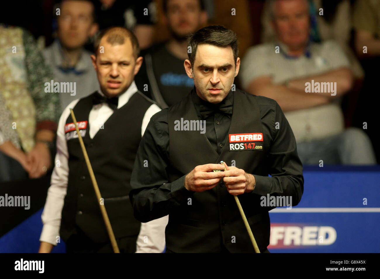 Barry Hawkins and Ronnie O'Sullivan (right) during day nine of the Betfred Snooker World Championships at the Crucible Theatre, Sheffield. Stock Photo