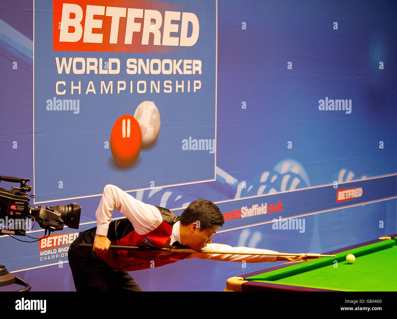 Ding Junhui during day nine of the Betfred Snooker World Championships at the Crucible Theatre, Sheffield. Stock Photo