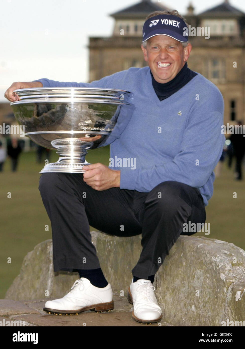 Scotland's Colin Montgomerie holds the trophy after winning the Dunhill