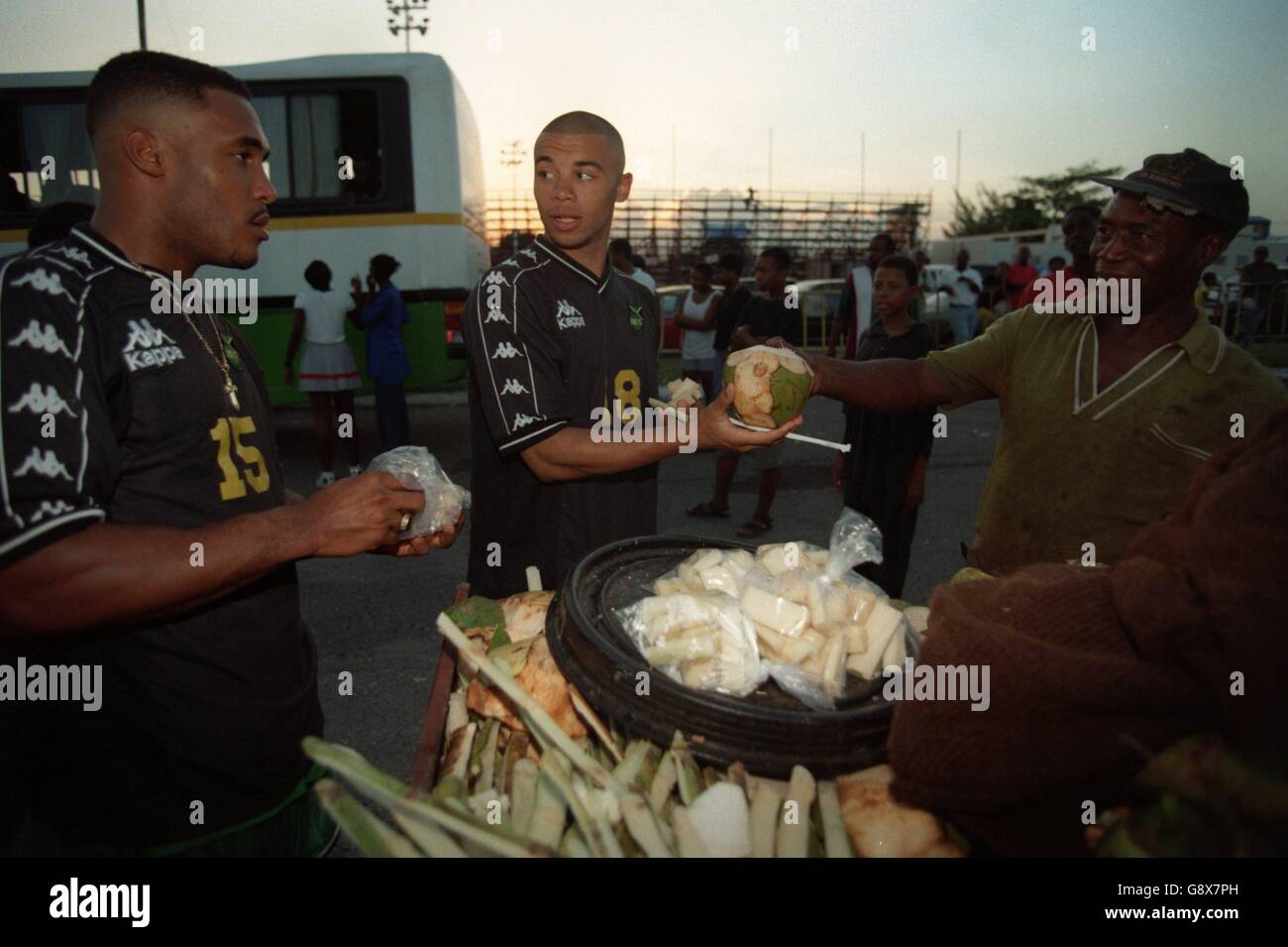 Soccer - World Cup Qualifier - Jamaica v Mexico. Jamaica's Deon Burton (centre) buys a coconut before the game Stock Photo