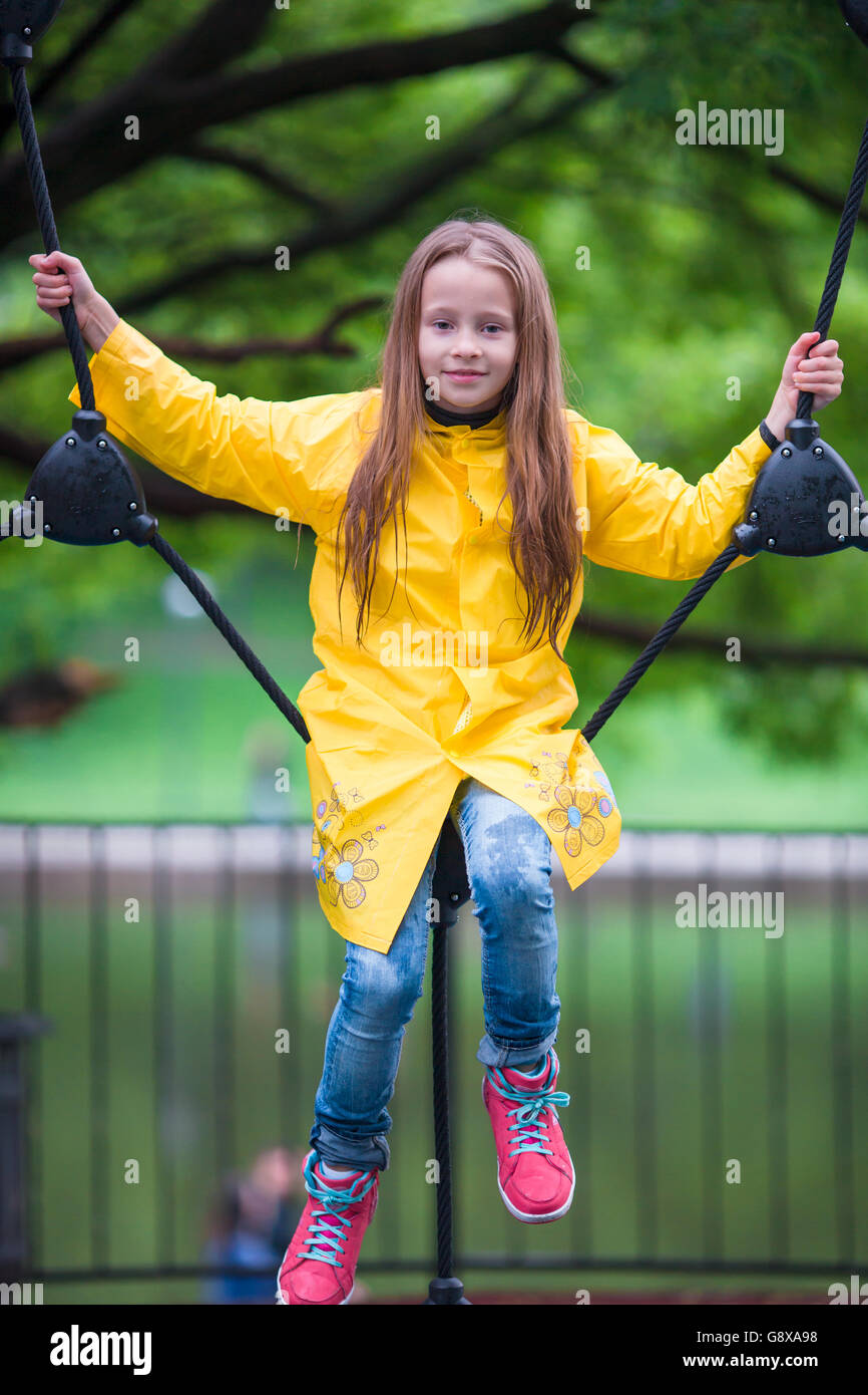 Happy little girl playng on outdoor playground Stock Photo - Alamy