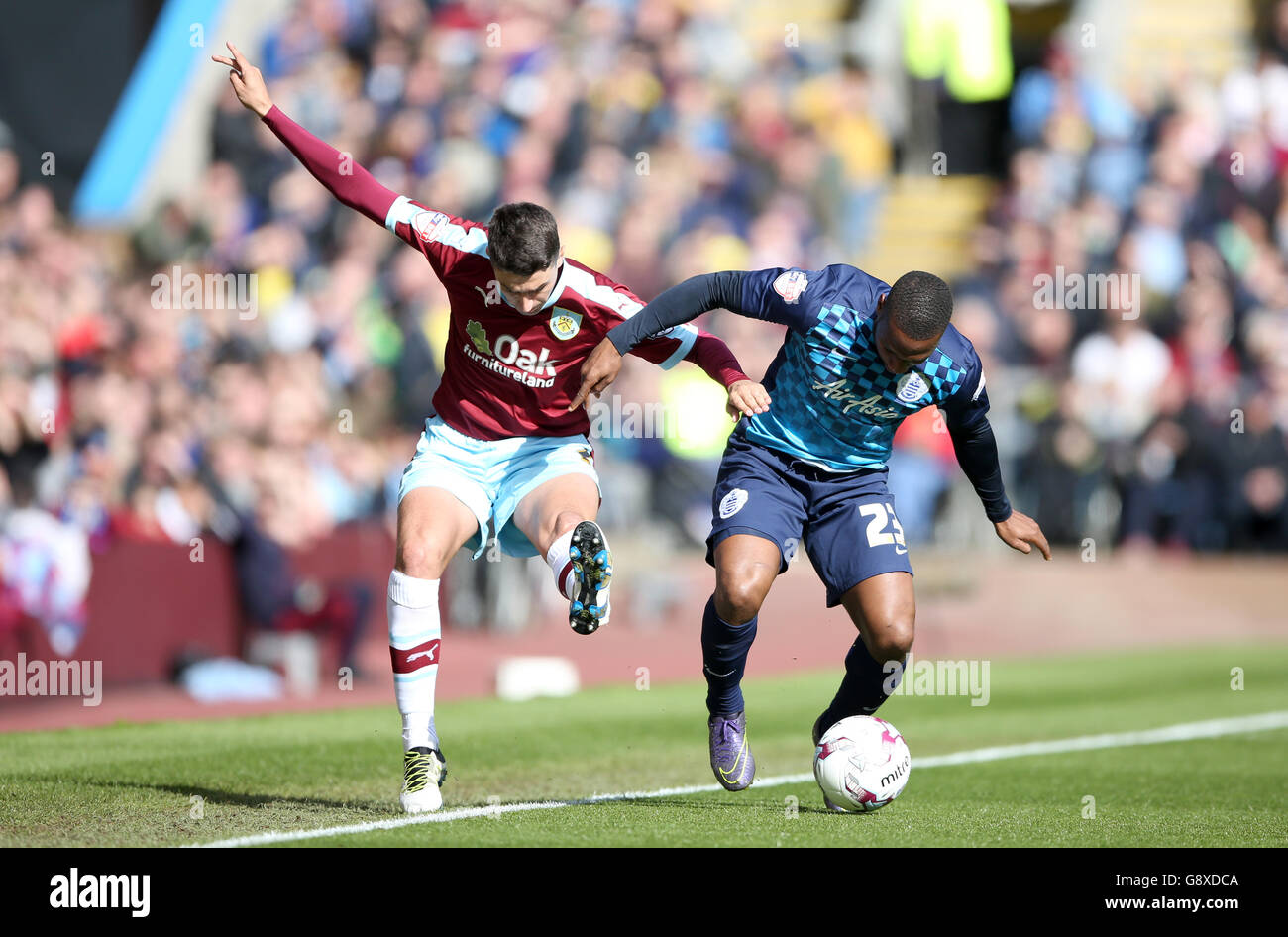 Burnley's Matthew Lowton (left) and Queens Park Rangers' Junior Hoilett battle for the ball during the Sky Bet Championship match at Turf Moor, Burnley. PRESS ASSOCIATION Photo. Picture date: Monday May 2, 2016. See PA story SOCCER Burnley. Photo credit should read: Tim Goode/PA Wire. Stock Photo