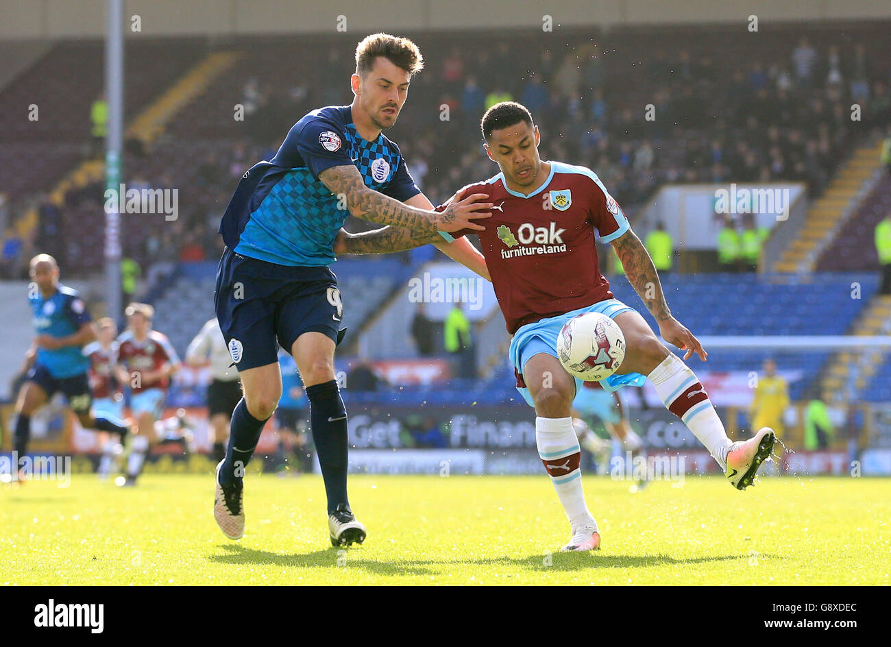 Burnley's Andre Gray (right) and Queens Park Rangers' Grant Hall battle for the ball during the Sky Bet Championship match at Turf Moor, Burnley. Stock Photo