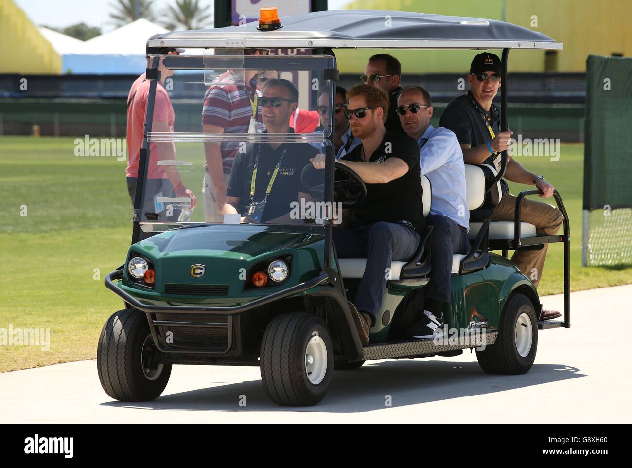 Prince Harry drives a golf buggy during the Jaguar Land Rover Discovery