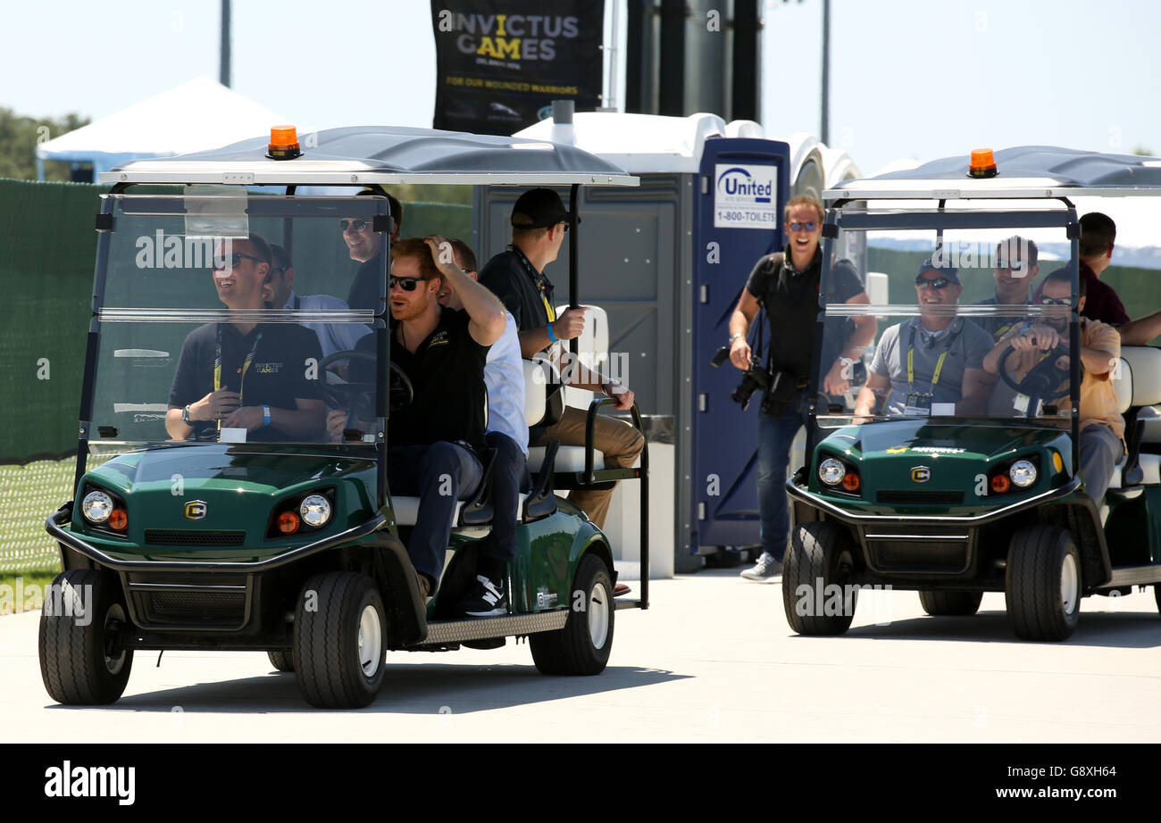 Prince Harry drives a golf buggy during the Jaguar Land Rover Discovery