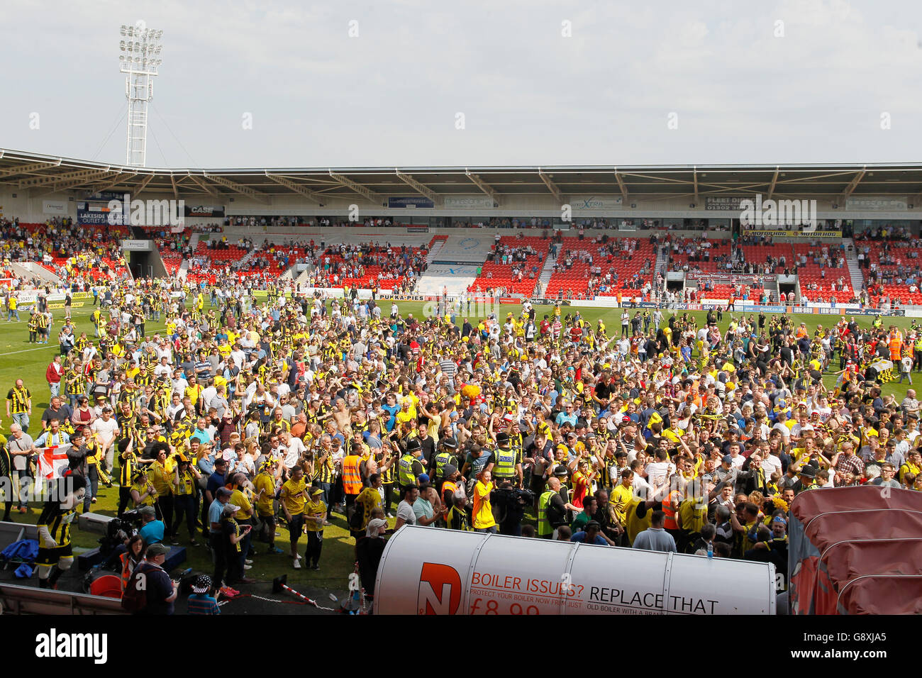 Burton Albion fans run onto the pitch to celebrate promotion after the ...