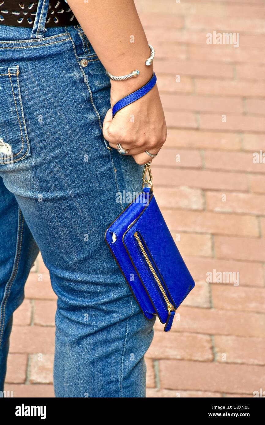 Woman holding blue Michael Kors wallet in her hand Stock Photo - Alamy