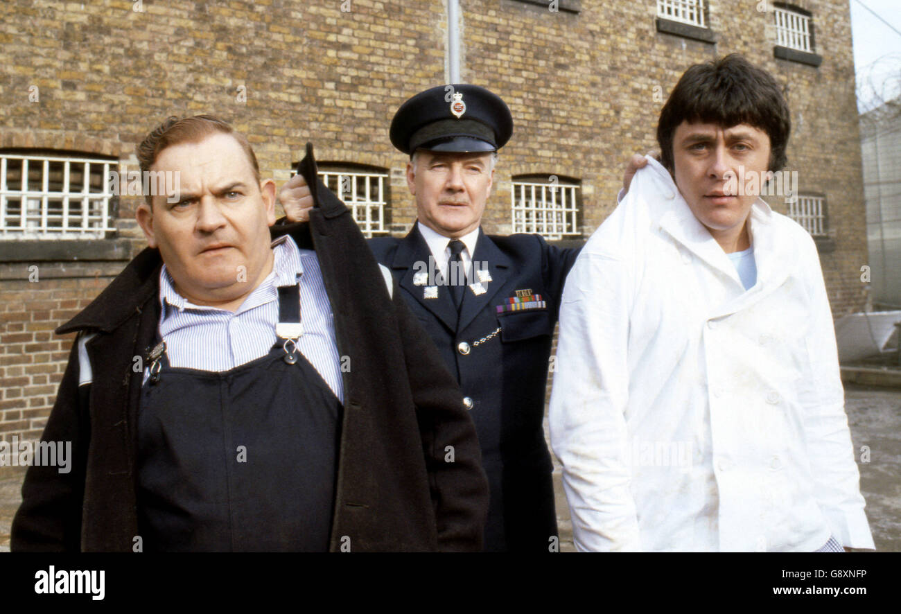 Old lag Fletcher (Ronnie Barker), fellow prisoner Godber (Richard Beckinsale) and prison officer Mackay (Fulton Mackay) during location shooting for the film version of their TV series 'Porridge' at Chelmsford Jail, which has been empty since a fire last year. Stock Photo