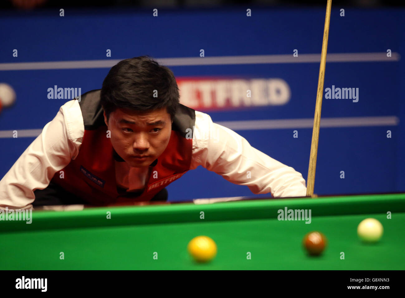 Ding Junhui during day fifteen of the Betfred Snooker World Championships at the Crucible Theatre, Sheffield. Stock Photo