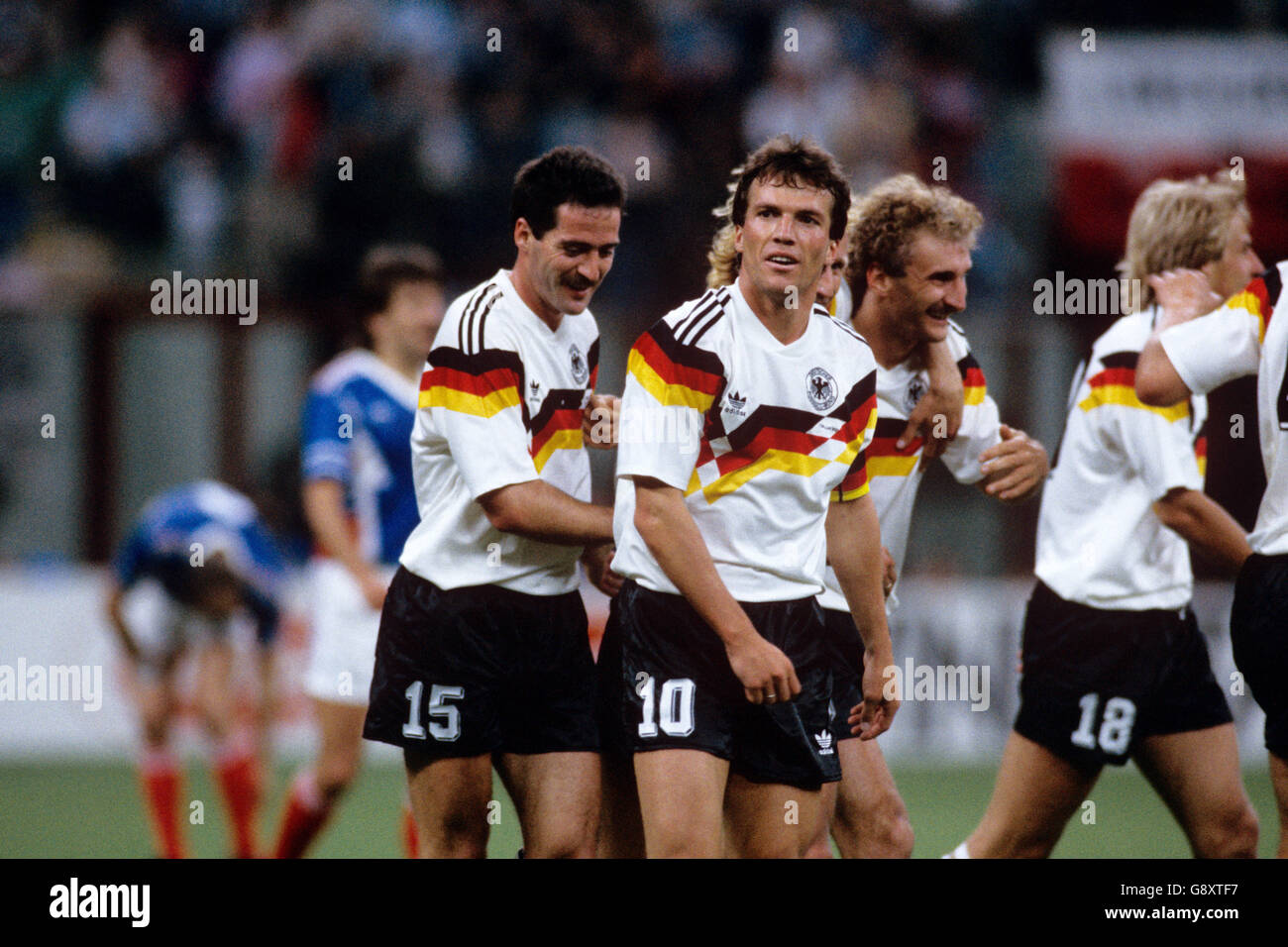 Soccer - World Cup Italia 90 - Group D - West Germany v Yugoslavia. West Germany's Lothar Matthaus (centre) is congratulated after scoring his team's third goal Stock Photo