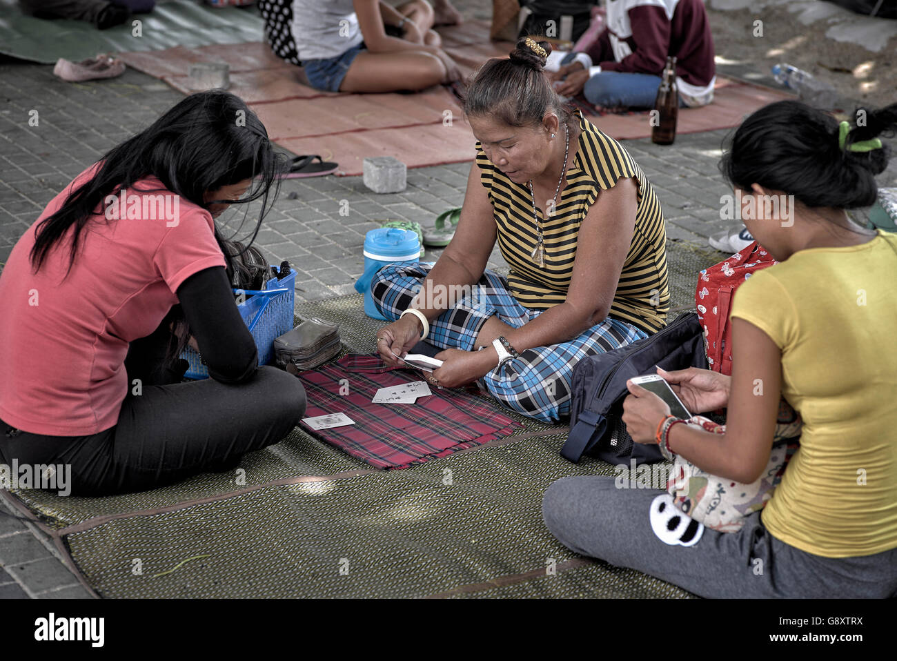 Fortune teller reading cards with customer on a Thailand street
