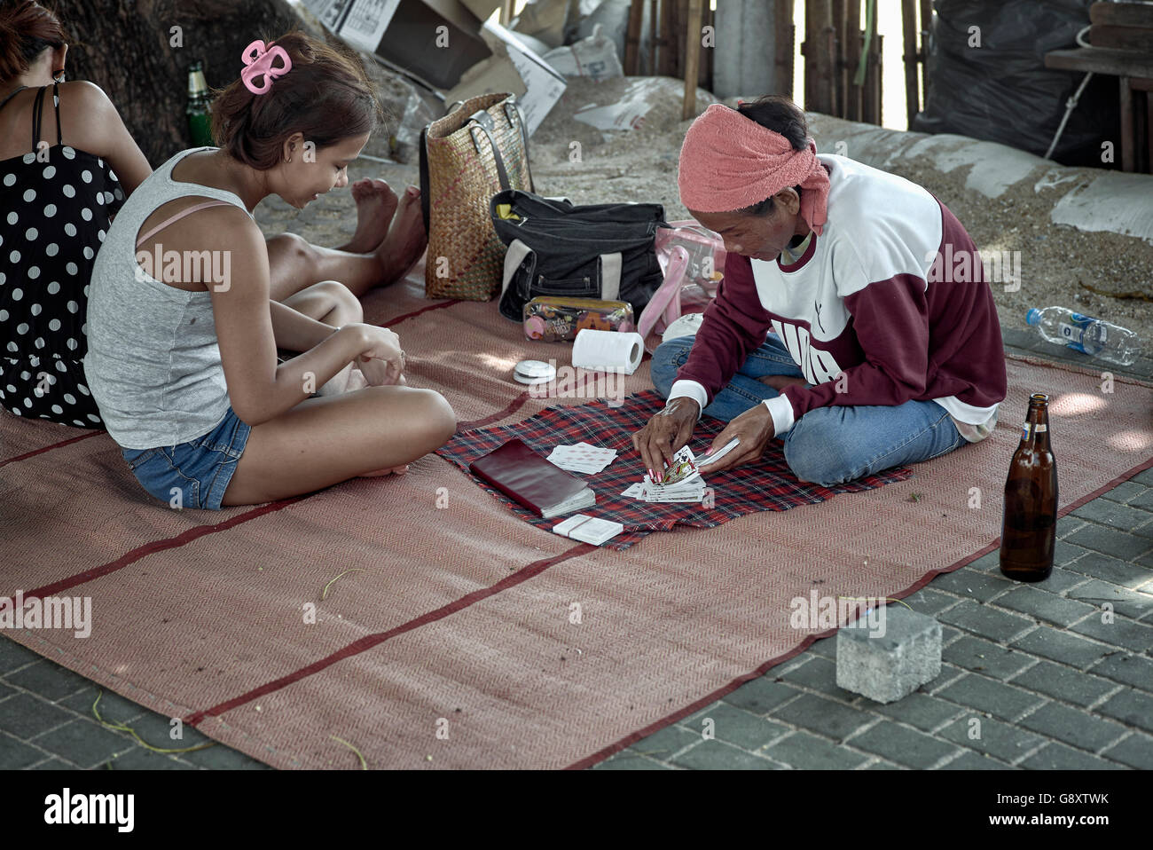 Fortune teller reading cards with customer on a Thailand street