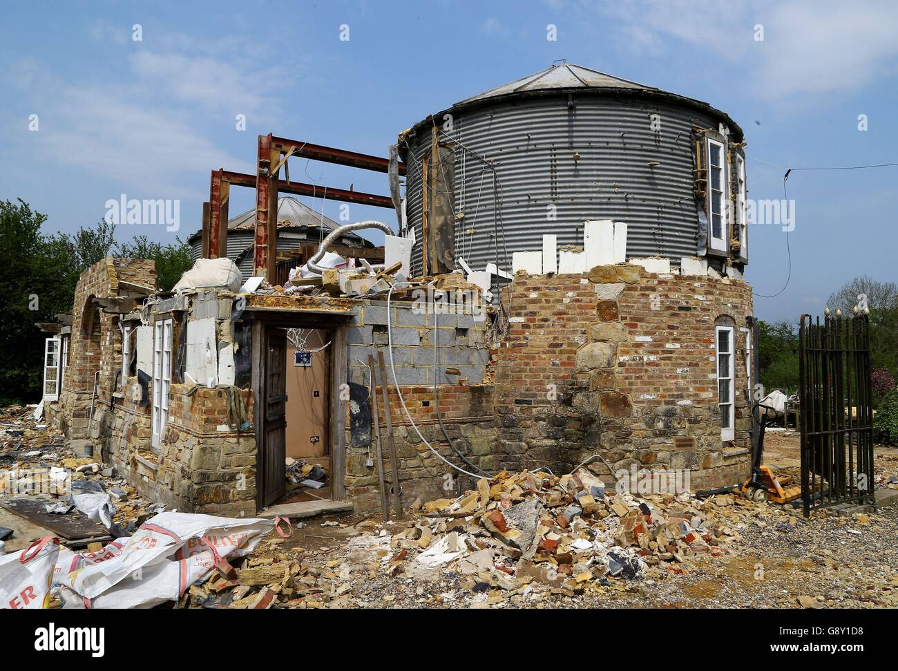 A view of the home of cattle farmer Robert Fidler on his farm in Salfords near Redhill in Surrey, as the process of demolishing the property continues after he lost a ten year court battle to save the property. Stock Photo