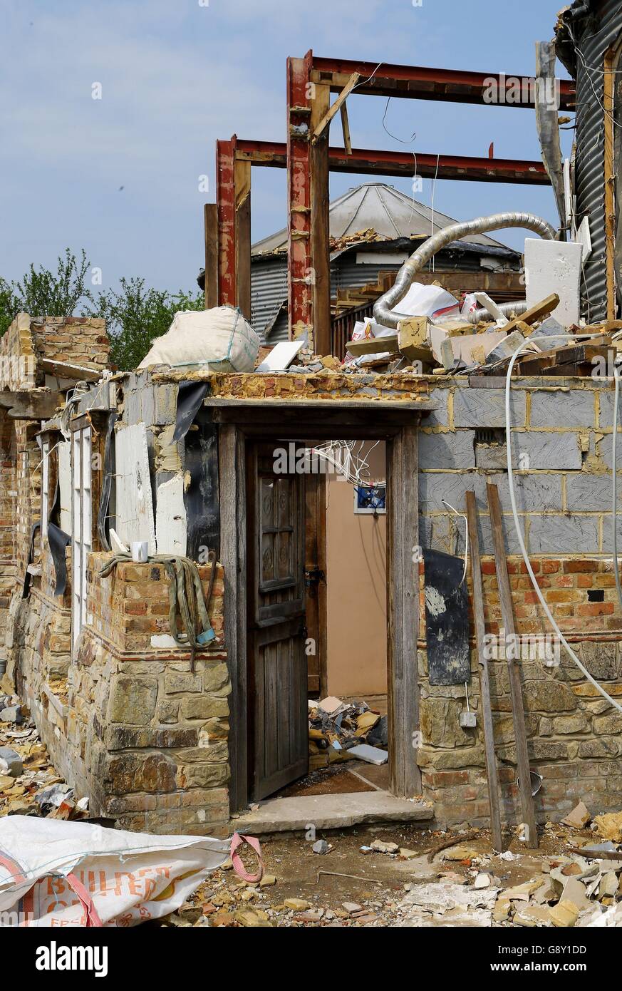 A view of the home of cattle farmer Robert Fidler on his farm in Salfords near Redhill in Surrey, as the process of demolishing the property continues after he lost a ten year court battle to save the property. Stock Photo