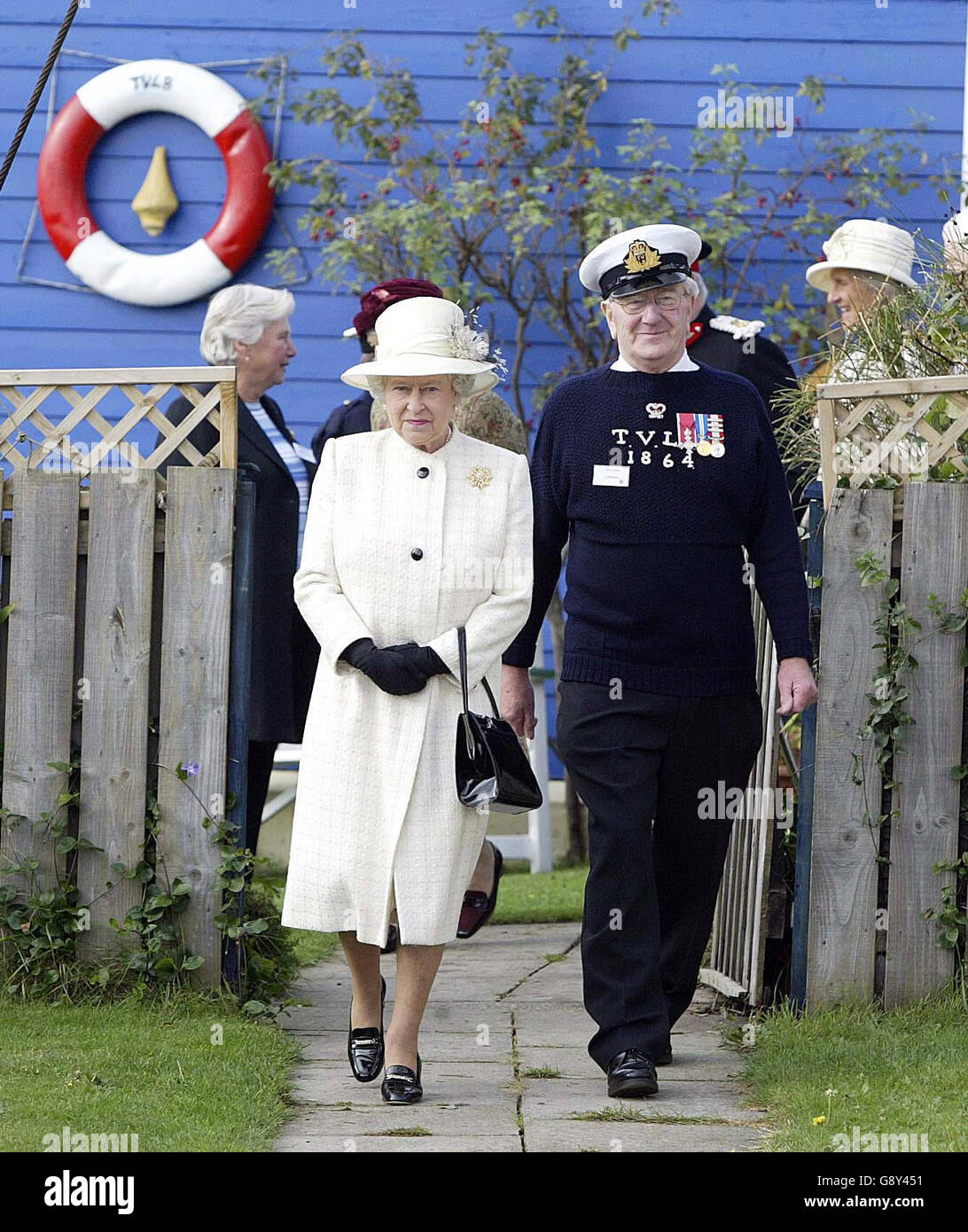 Britain's Queen Elizabeth II walks with Commander of the Tynemouth Volunteer Life Brigade Alec Hastie during her visit to the Tynemouth Volunteer Life Brigade Watch House and Museum, Friday October 14, 2005. See PA Story ROYAL Queen. PRESS ASSOCIATION Photo. Photo credit should read: Owen Humphreys/PA/WPA Rota Stock Photo