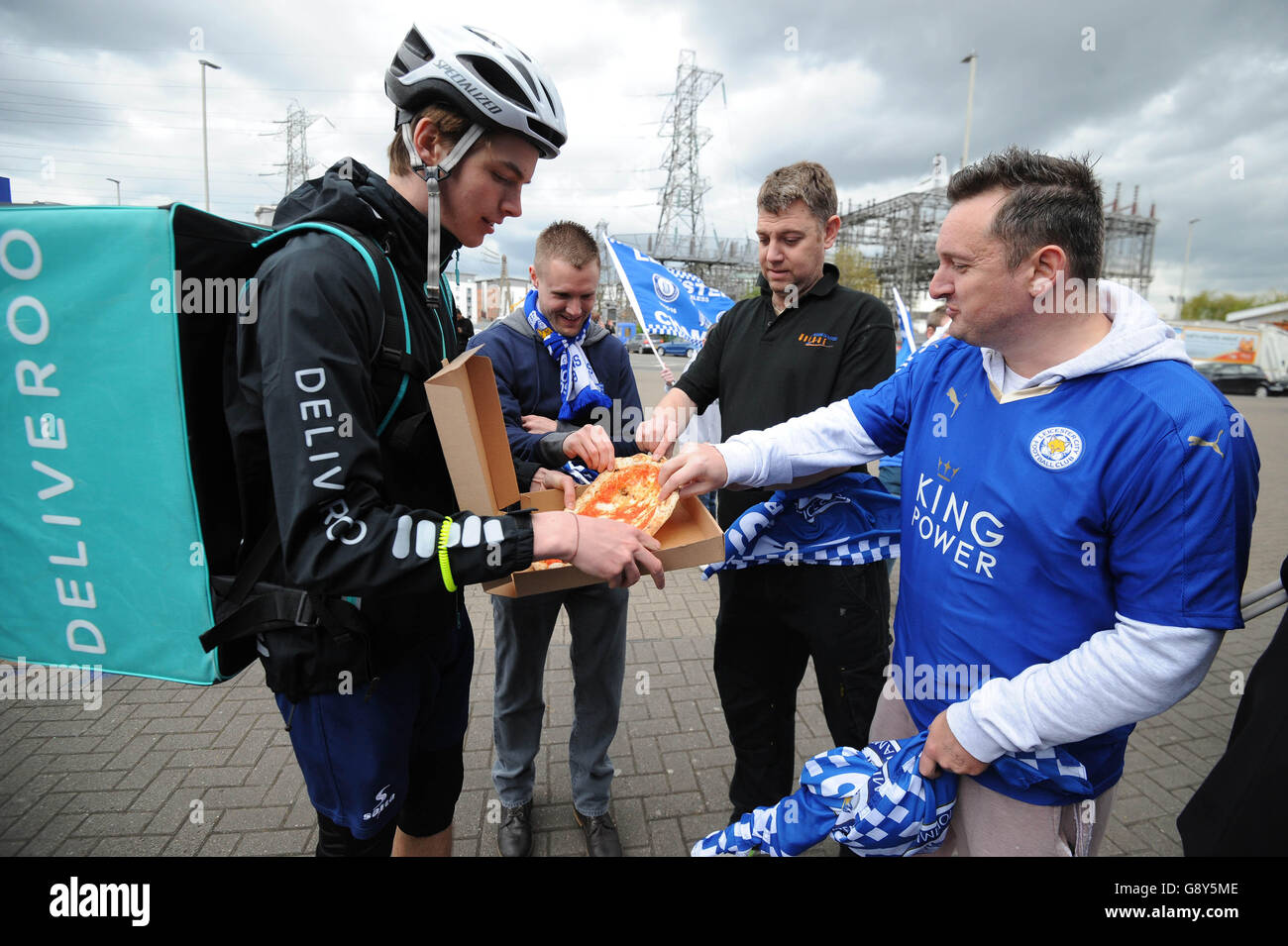 A Deliveroo rider delivers freebies from Peter Pizzeria to Leicester City FC fans outside the King Power Stadium in Leicester, ahead of the team lifting the Barclays Premier League trophy this weekend. Stock Photo