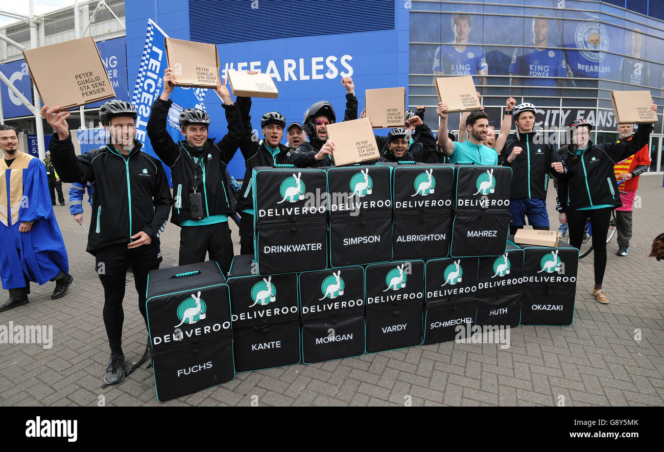 A team of Deliveroo riders named after Leicester City FC players pose outside the King Power Stadium in Leicester, where they delivered freebies from Peter Pizzeria to football fans in celebration of the club winning the Barclays Premier League, ahead of the team lifting the trophy this weekend. Stock Photo