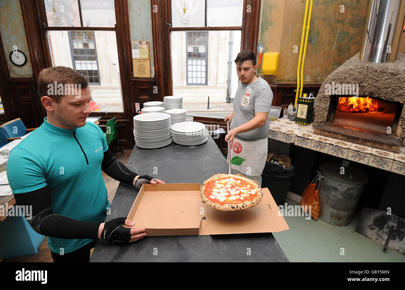 EDITORIAL USE ONLY A Deliveroo rider sets off from Peter Pizzeria in Leicester to deliver freebies to football fans in celebration of Leicester City FC winning the Barclays Premier League, ahead of the team lifting the trophy this weekend. Stock Photo