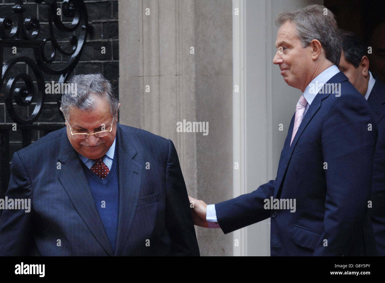 Britain's Prime Minister Tony Blair (R) with Iraqi president Jalal Talabani outside 10, Downing Street, central London, Thursday October 6, 2005. Blair met the Iraqi president to discuss preparations for the referendum on the new Iraqi constitution. The Iraqi leader is visiting London during his first official visit to Europe since taking office in April. The meeting comes a day after a senior British official blamed Iran's Revolutionary Guard for supplying the lethal explosive technology responsible for killing British soldiers in Iraq. The official said that there was evidence that the Stock Photo