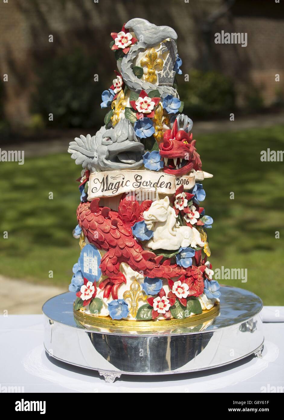 The ornate cake decorated with dragons and magical creatures viewed by the Duchess of Cambridge at Hampton Court's Magic Garden, marking the official opening of the palace's new children's play area. Stock Photo