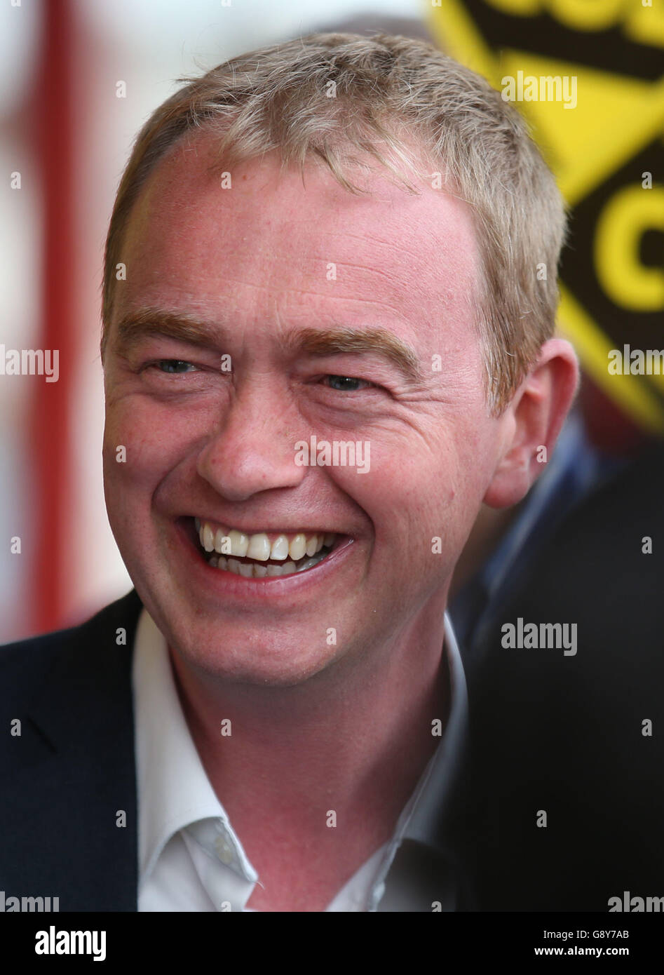 Liberal Democrat leader Tim Farron, smiles as he joins Scottish Liberal Democrat leader Wiilie Rennie and fellow Lib Dem Alex Cole-Hamilton, as they celebrate in Edinburgh, after Rennie and Cole-Hamilton both won their seats in the Scottish parliamentary elections. Stock Photo