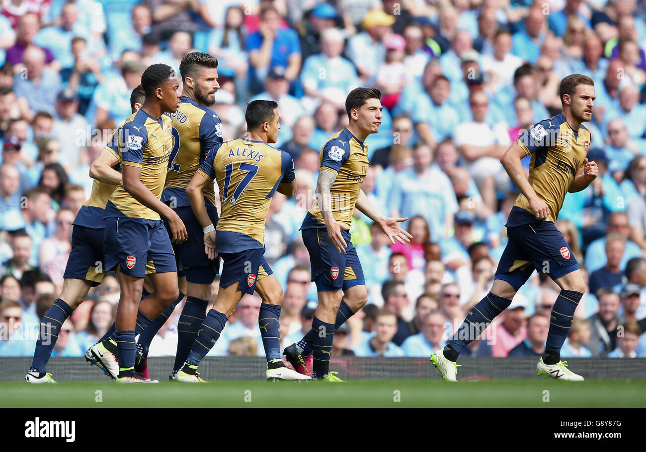 Arsenal's Olivier Giroud (3rd left) celebrates scoring his side's first goal during the Barclays Premier League match at the Etihad Stadium, Manchester. Stock Photo