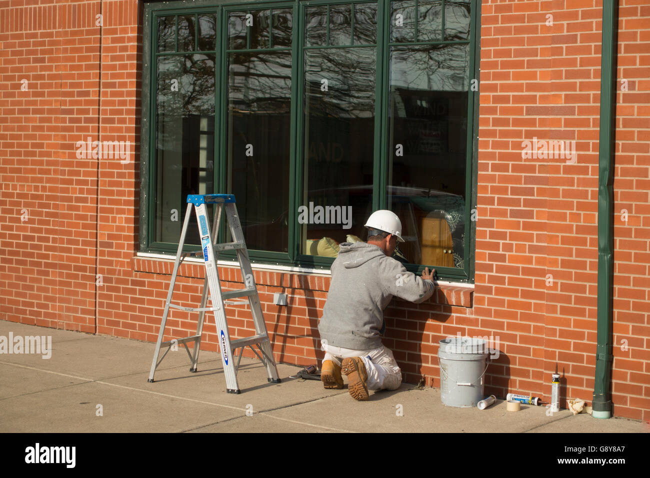 construction worker caulking window in Newport RI Stock Photo Alamy