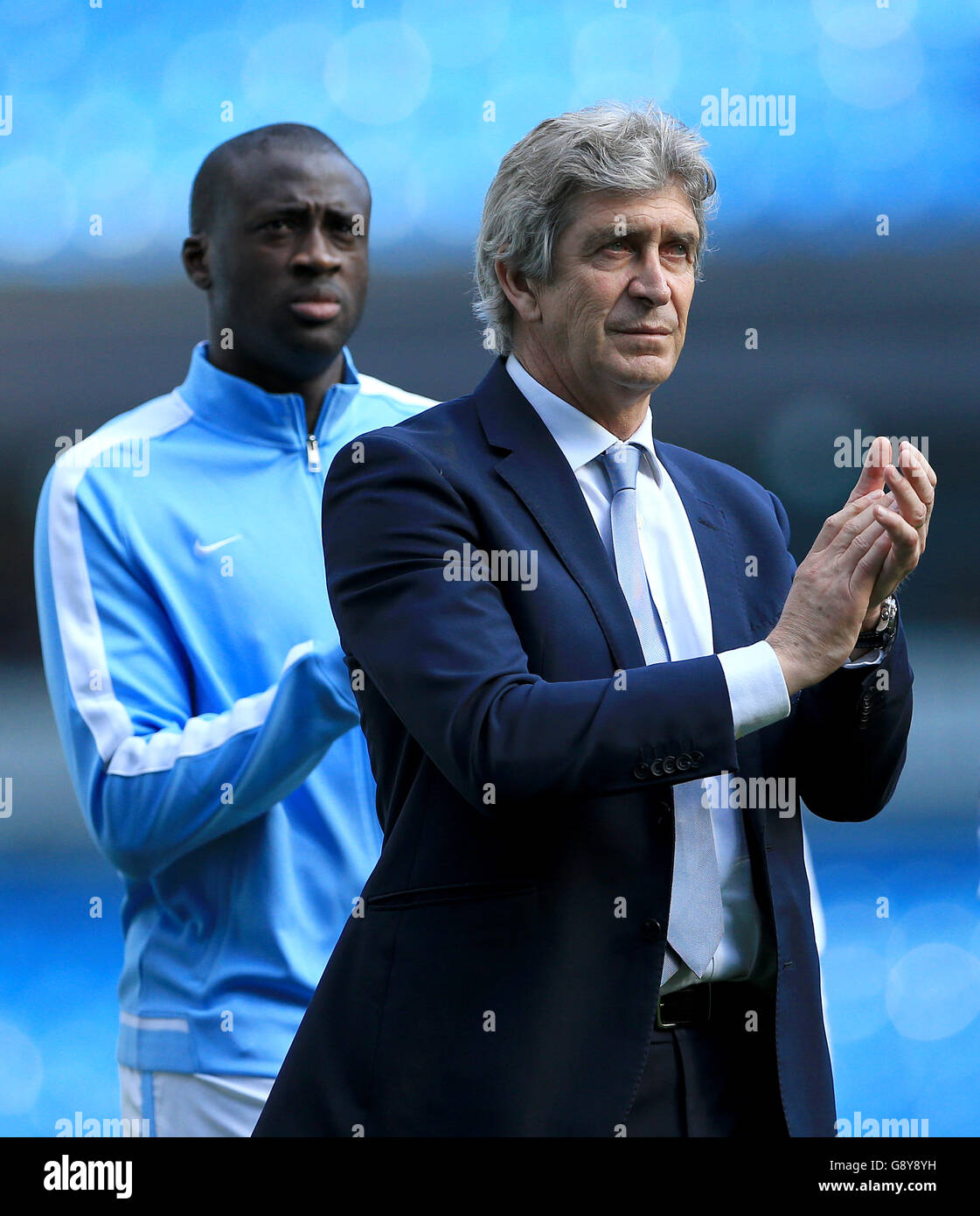 Manchester City manager Manuel Pellegrini applauds the fans after the game with Yaya Toure during the Barclays Premier League match at the Etihad Stadium, Manchester. Stock Photo