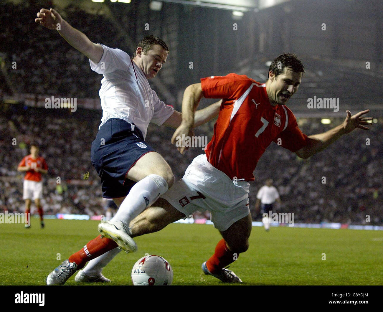 England's Wayne Rooney (L) challeges Poland's Radoslaw Sobolewski during the World Cup qualifying match at Old Trafford, Manchester, Wednesday October 12, 2005. PRESS ASSOCIATION Photo. Photo credit should read: Owen Humphreys/PA. Stock Photo