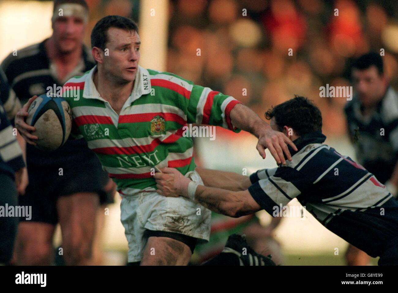 Leicester's Joel Stransky (left) looks for an option as he is held by Tigger Dawson of Coventry (right) Stock Photo
