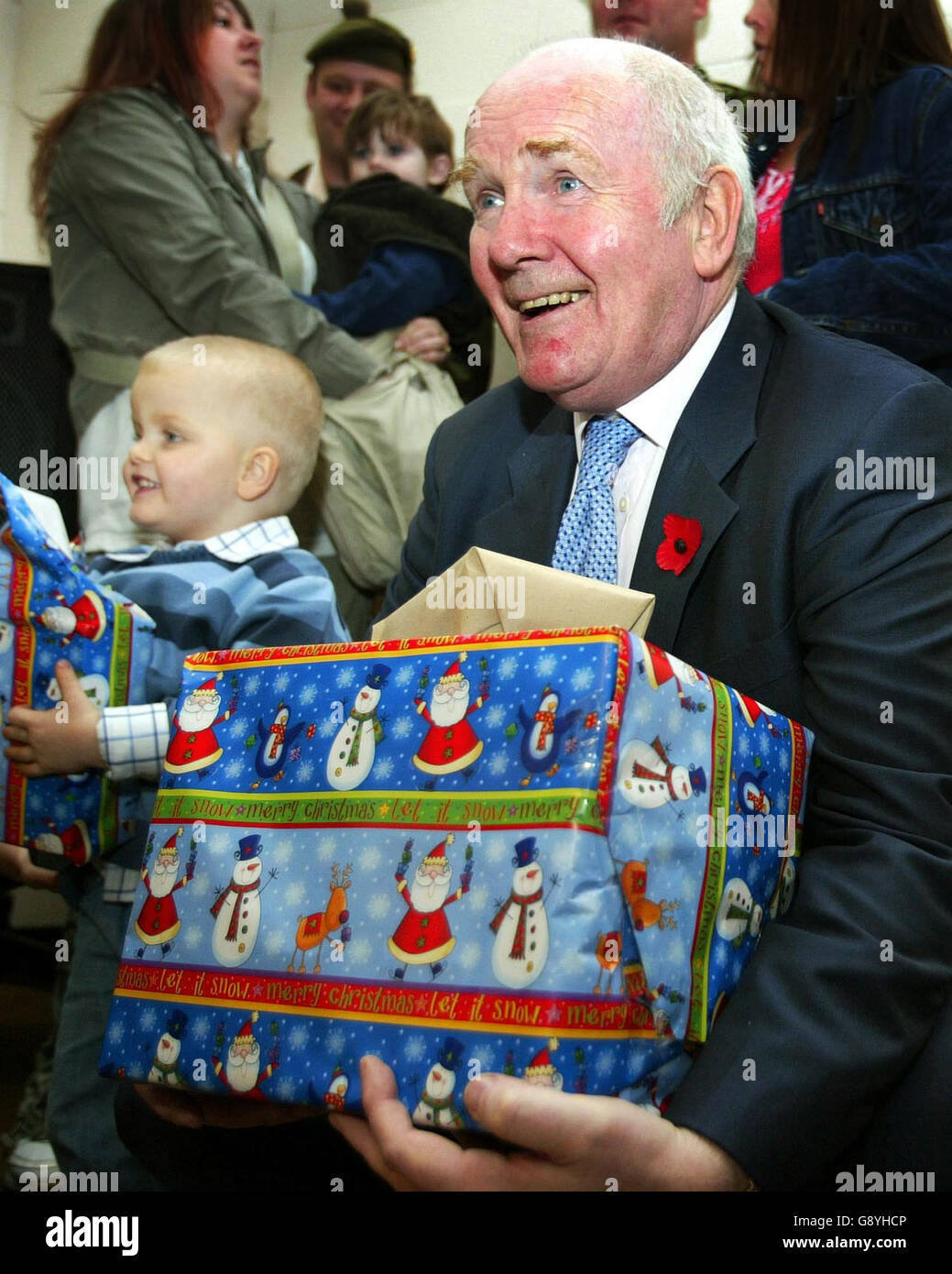 Defence Secretary Dr John Reid carries Christmas parcels at Redford