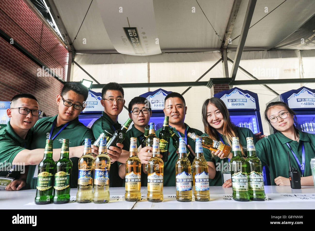 Harbin, China's Heilongjiang Province. 30th June, 2016. Salesmen show different types of beer during the Harbin International Beer Festival in Harbin, capital of northeast China's Heilongjiang Province, June 30, 2016. Credit:  Wang Song/Xinhua/Alamy Live News Stock Photo